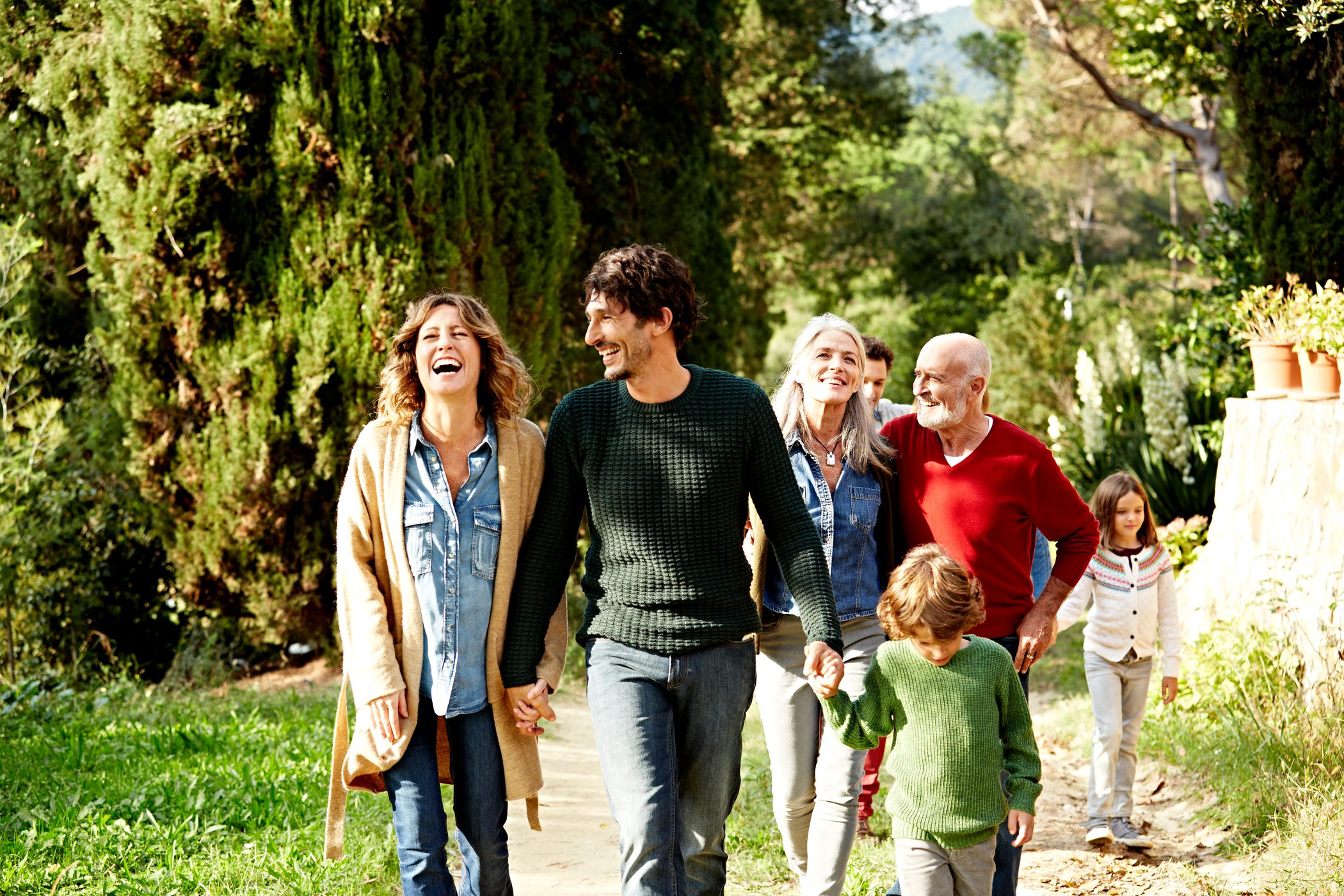 Stock image of family smiling and walking down street